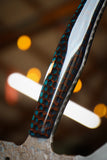 hatchet with wasp hive with teal backdrop