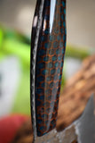 hatchet with wasp hive with teal backdrop