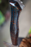hatchet with wasp hive with teal backdrop