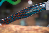 hatchet with wasp hive with teal backdrop